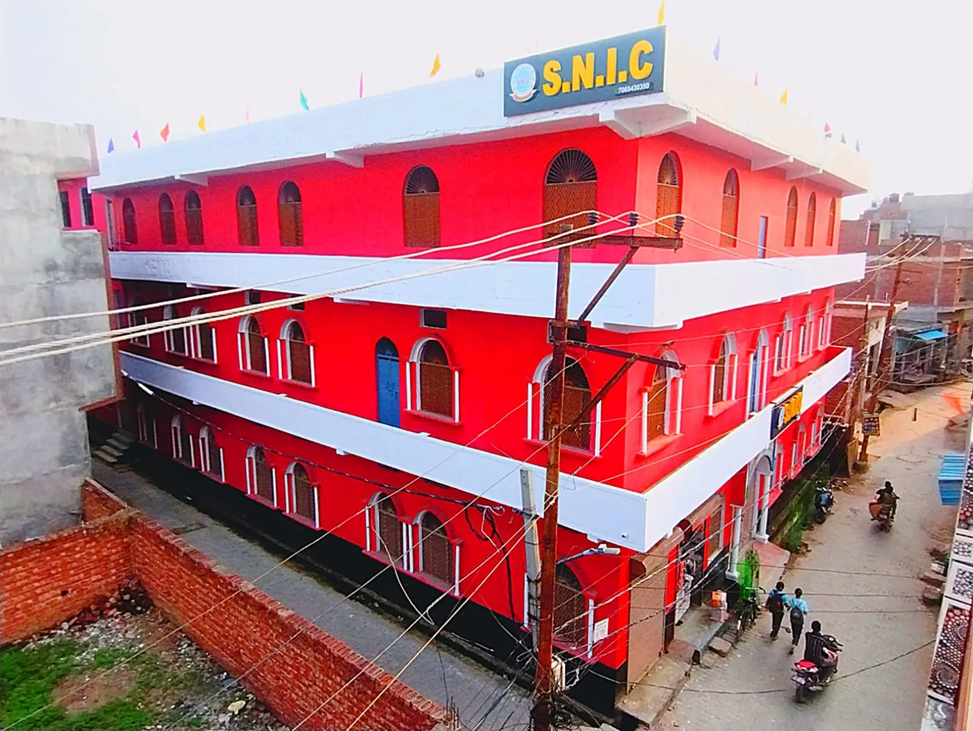 The S.N.I.C signboard on the roof of the Shanti Niketan Inter College building