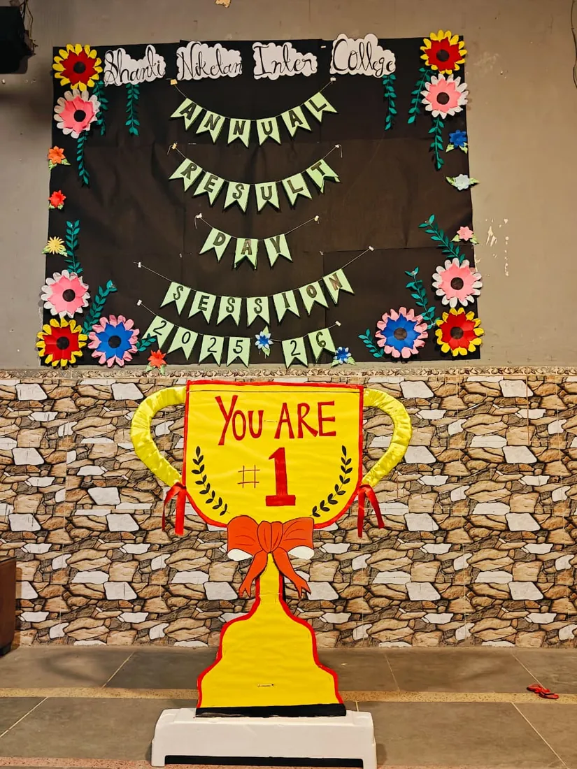 A decorated display board made by students, with paper flowers and a trophy cut-out