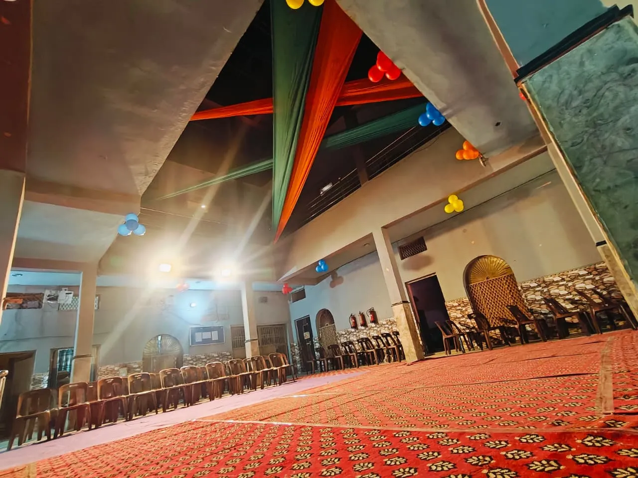 Interior of the assembly hall showing the decorated pillars and seating