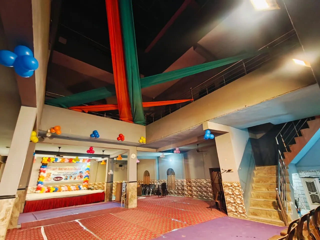 The assembly and function hall at Shanti Niketan Inter College, set out with seating and a decorated stage